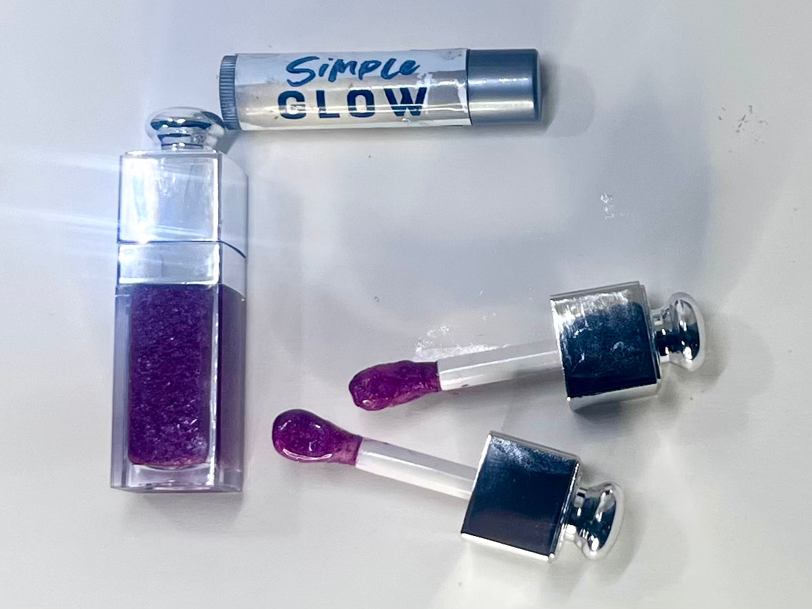 Pink glittery lip gloss set with 'Simple Glow' packaging on a white background