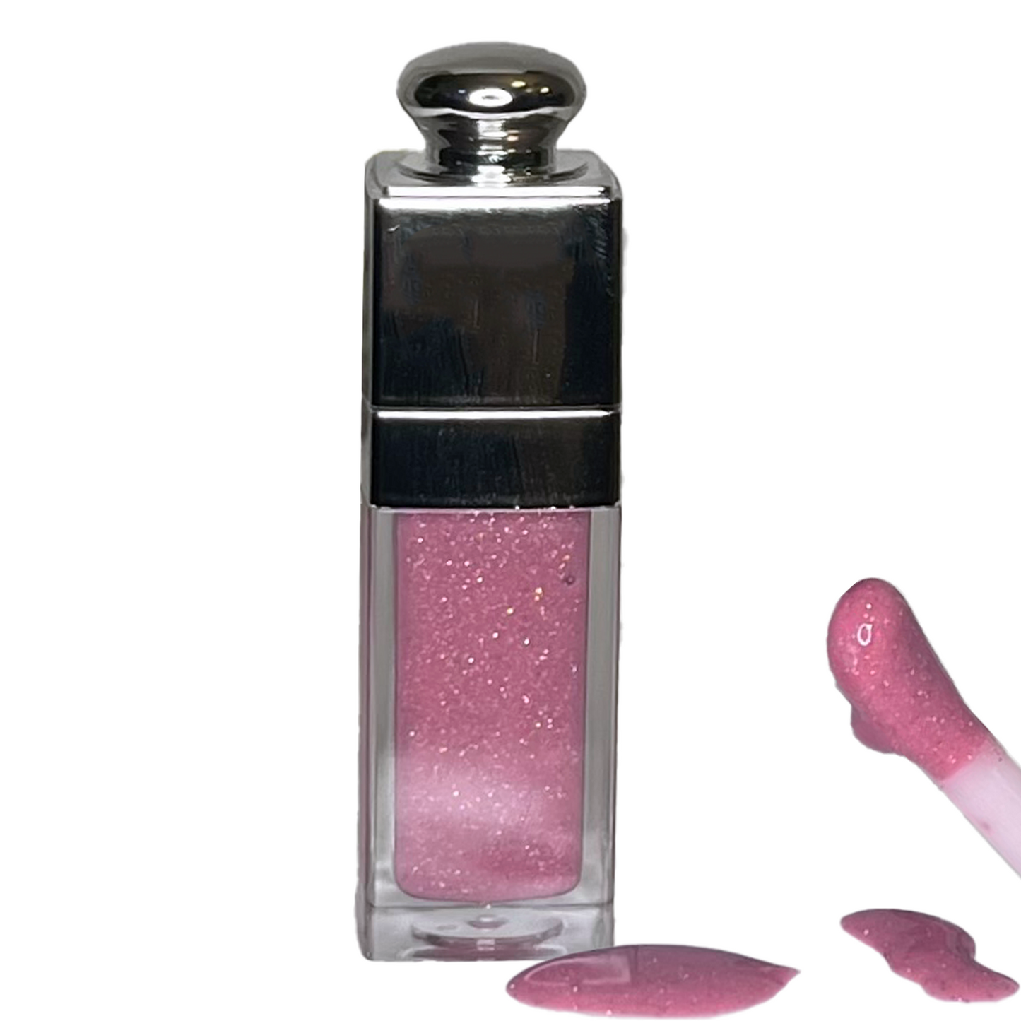 Pink glittery lip gloss with applicator on a white background
